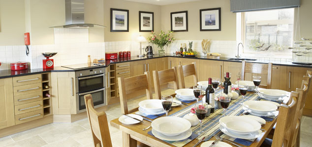 Modern kitchen with table set up for dinner