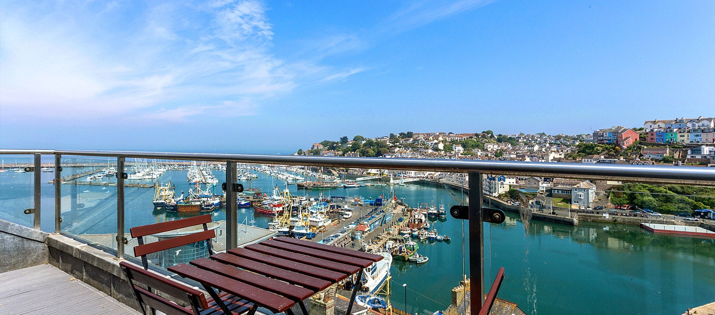 Balcony view of a busy harbour with blue skies