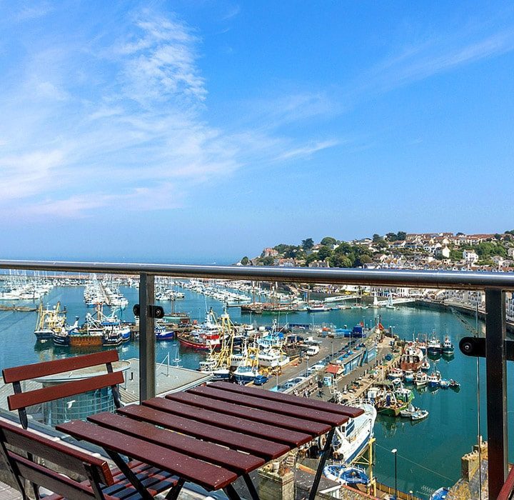 Balcony view of a busy harbour with blue skies