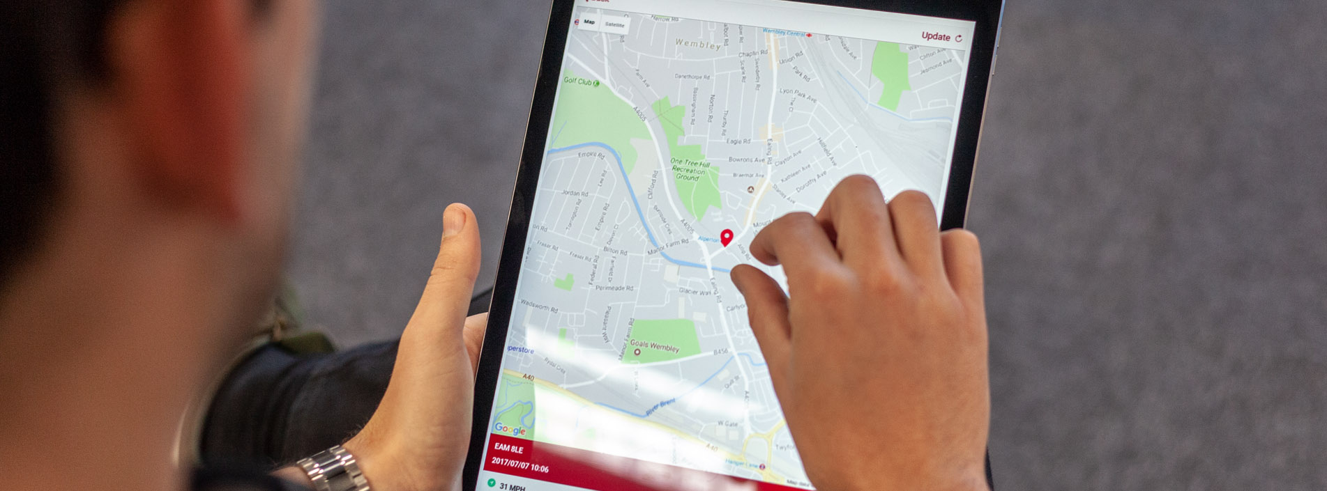 Mobile App Developer holiding ipad showing map development