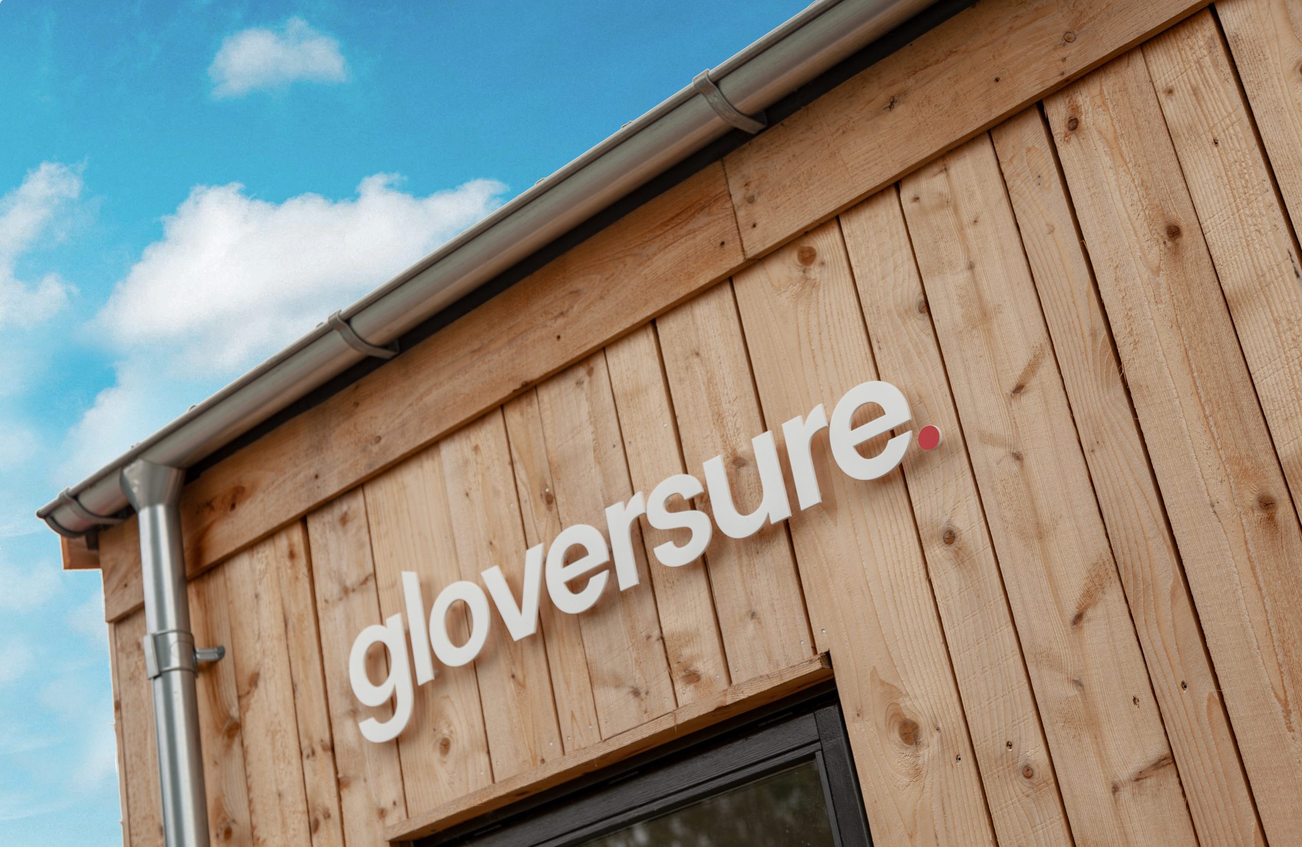 wooden gloversure office with large sign