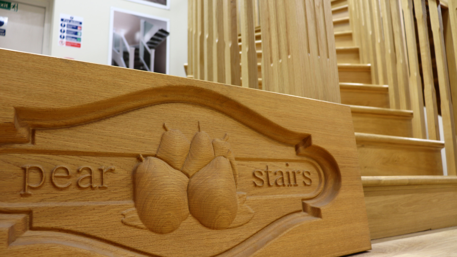 pear stairs wooden logo with wooden staircase behind it