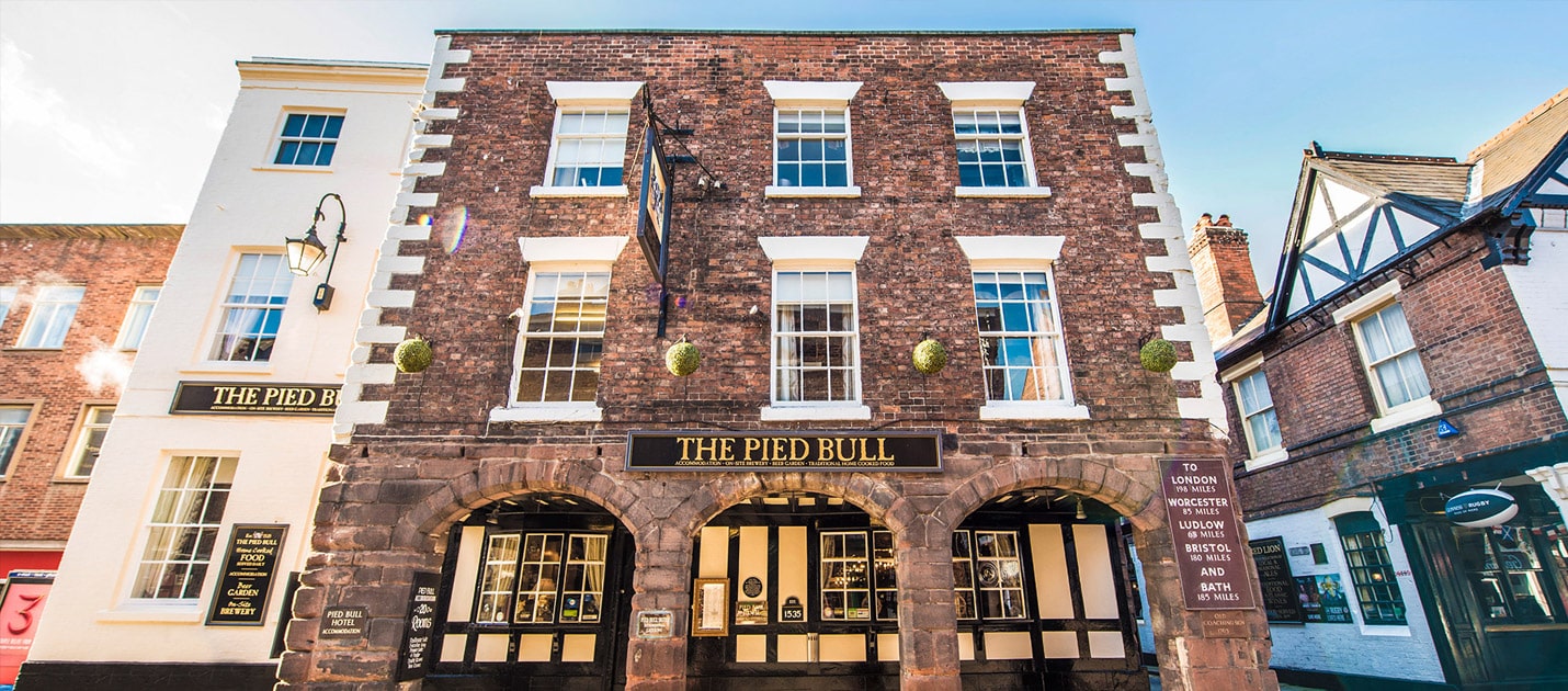 Frontal view of three story pub, the pied bull