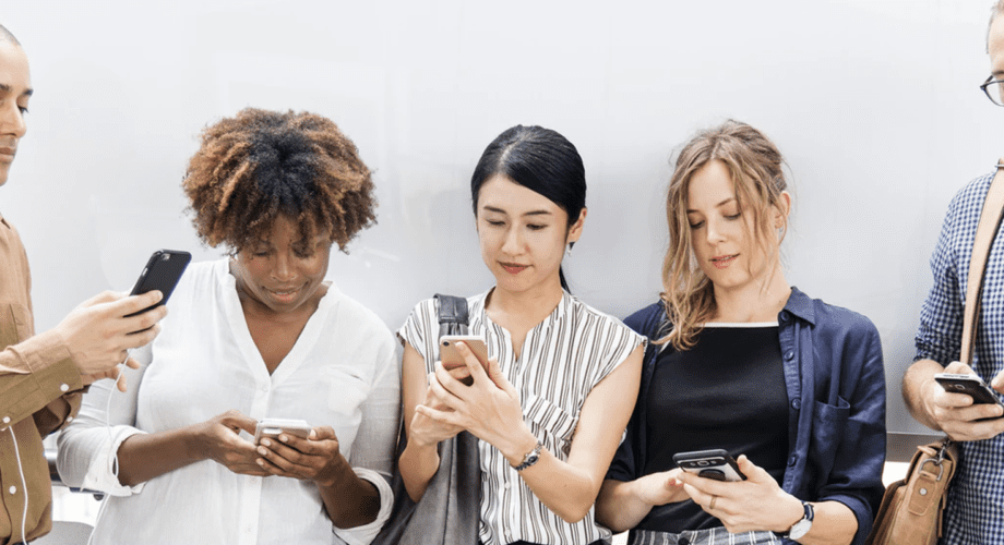 Five people lined up all looking at social media content on their phone