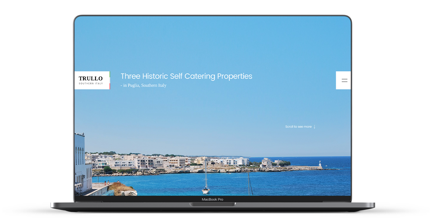 The Trullo Italy website home page displayed on an laptop, showing an italian harbour with blue skies