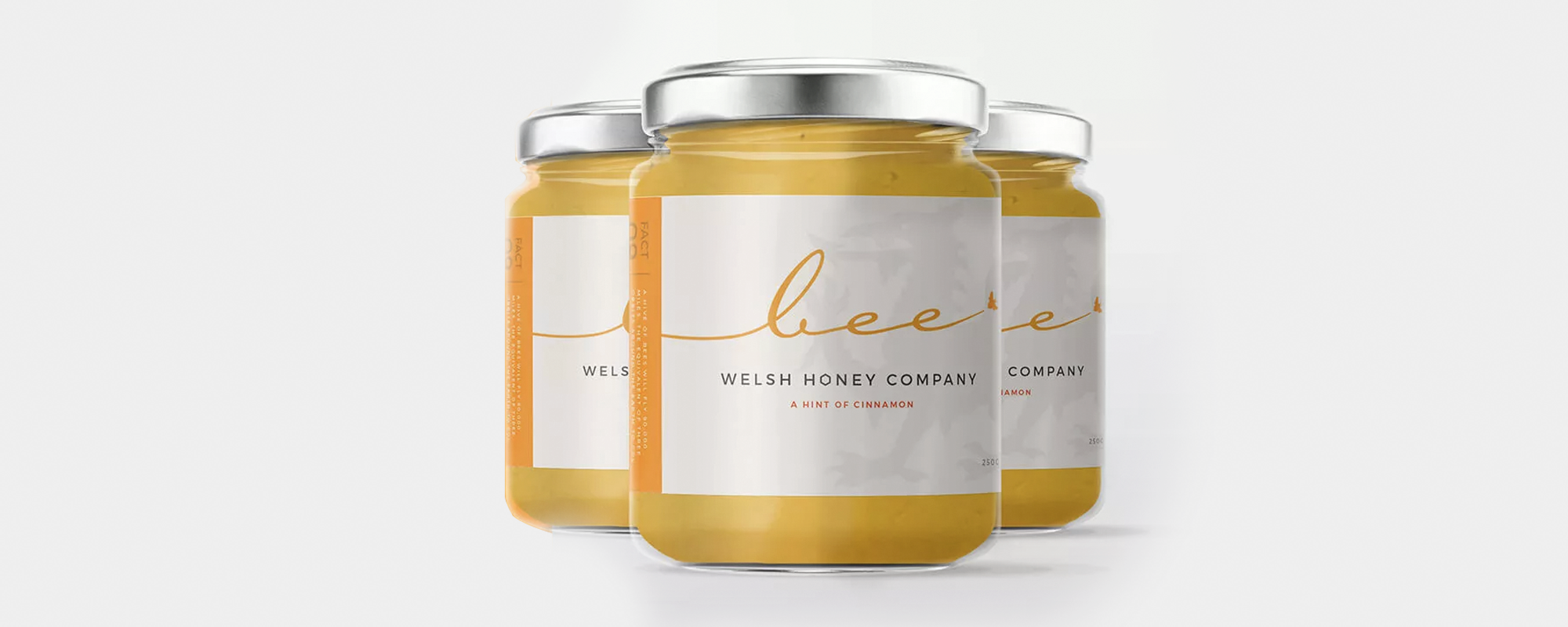 Food label branding for Bee Welsh Honey Company, shown on three jars of honey in a triangle