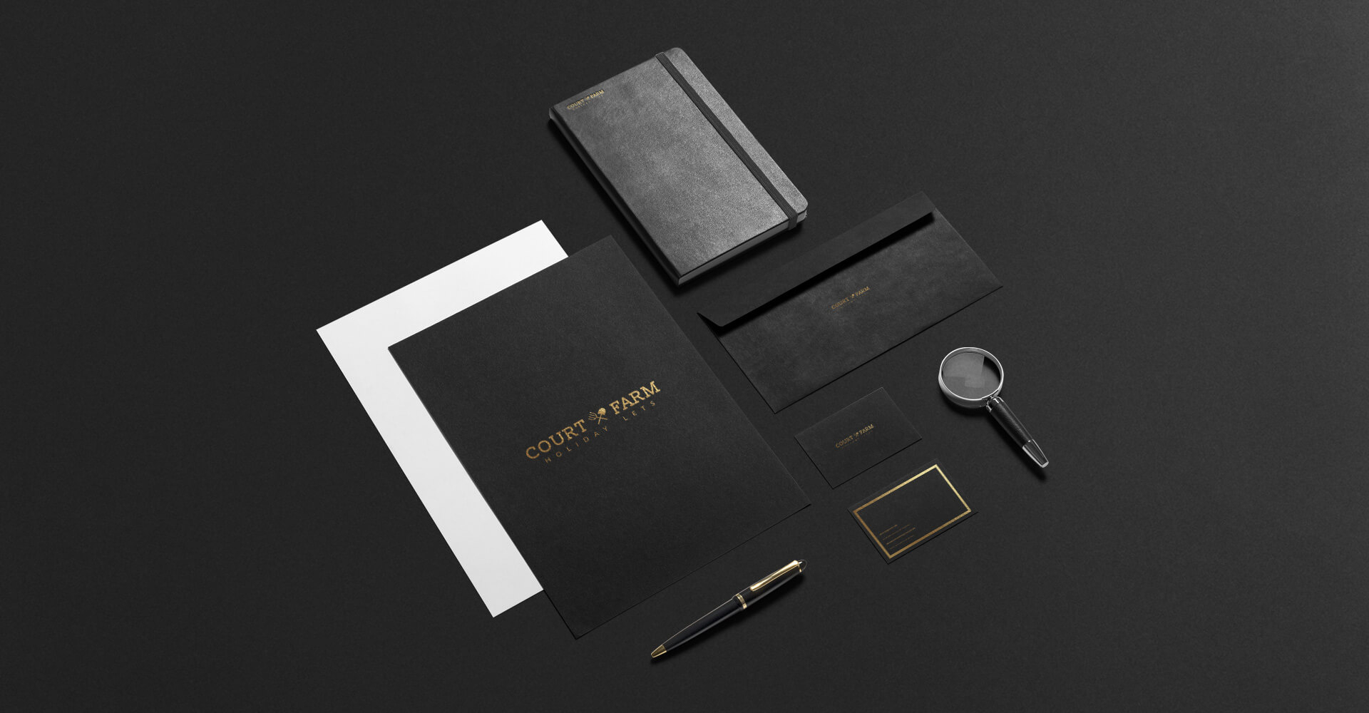 agricultural branding for court farm, in the form of a note pad, envelope, documents and a business card on a black surface