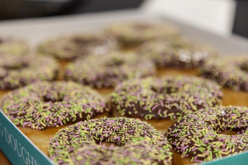 Choclate sprinkled doughnuts in a box