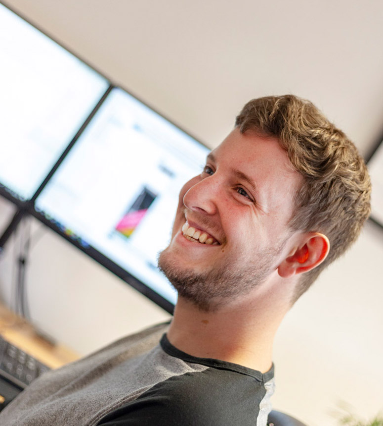 a member of the gloversure development team smiling in an office environment