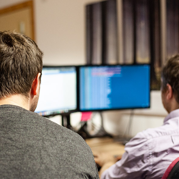 Two members of the development team work on some code
