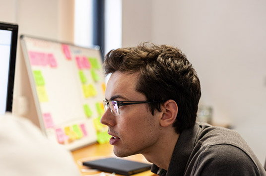 A websire developer looking into technical SEO fixes with sticky notes in the background