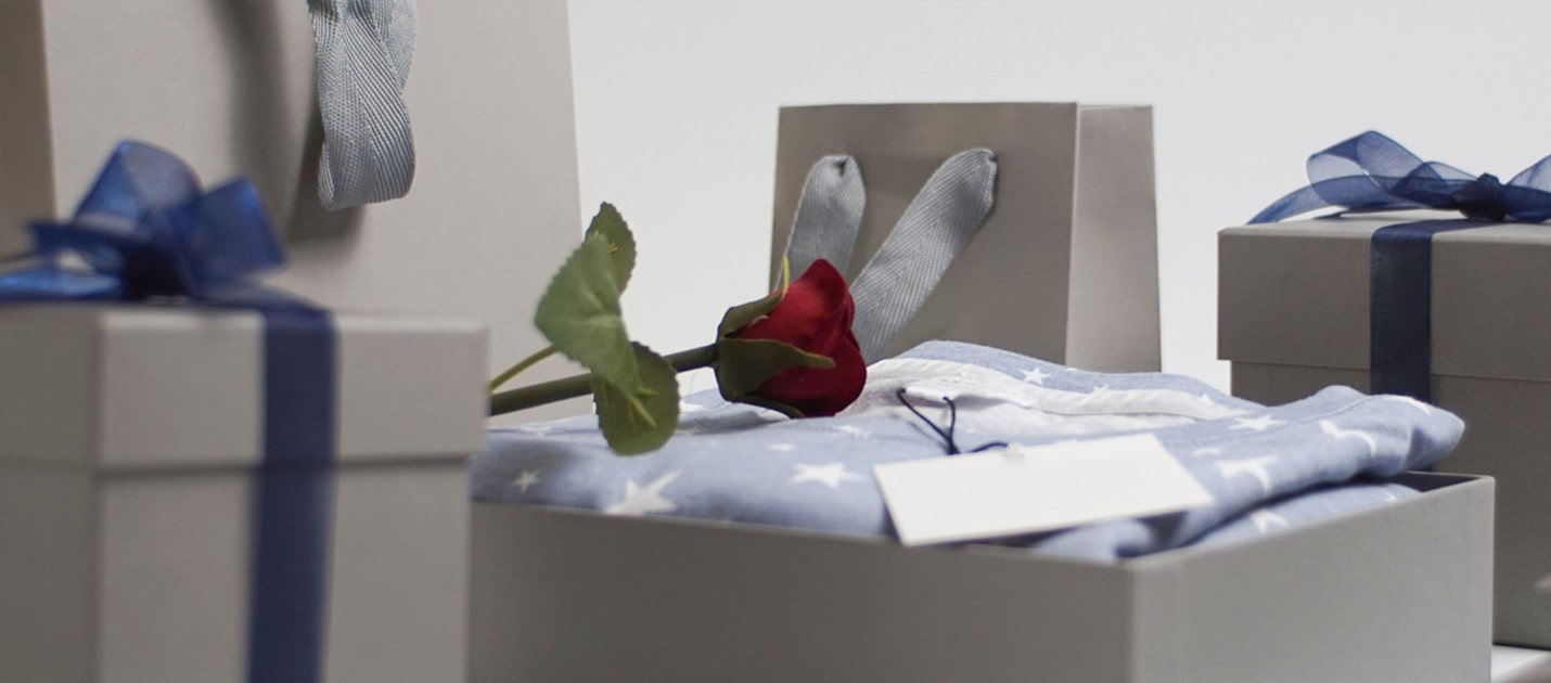 A fake rose on an open gift box
