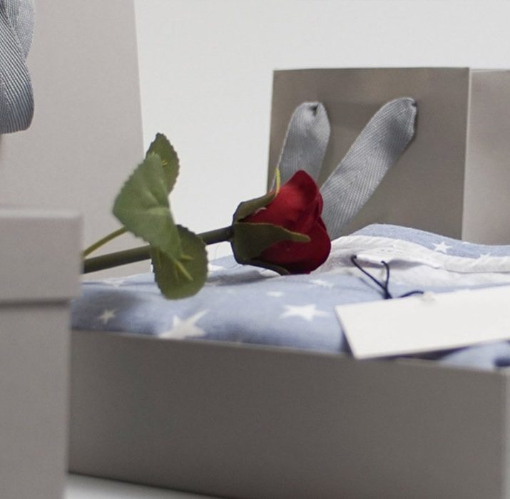 A fake rose on an open gift box