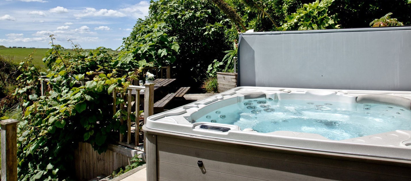 An open hot tub in a green setting