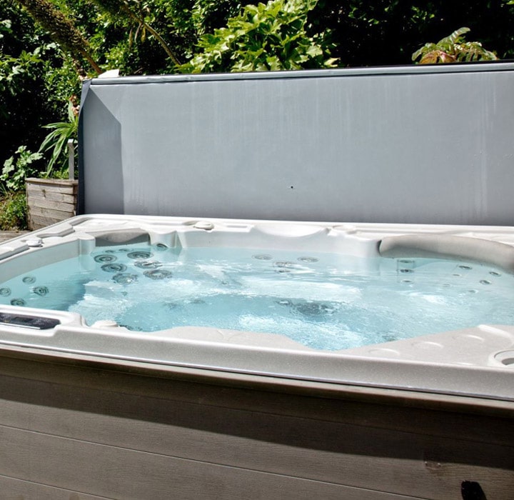 An open hot tub in a green setting