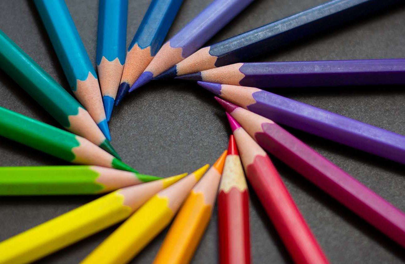 Multi-coloured colouring in pencils pin pointed into a circle