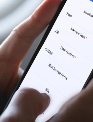 Work Forms custom development software shown on a mobile in a hand
