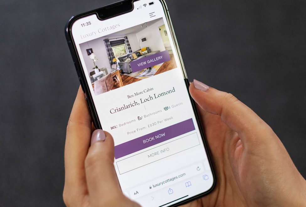 luxury holiday home web design displayed on an iPhone in a womens hand